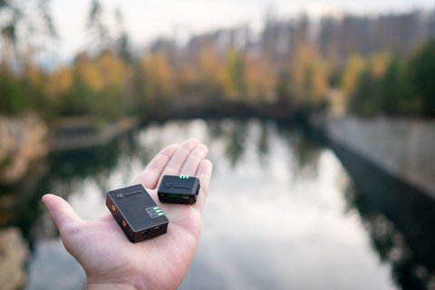Dronetag Mini and Dronetag Beacon held together on a hand